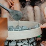 a person pouring water into a glass